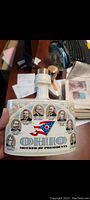 Front view of 1972 ceramic whiskey decanter decorated with portraits of Ohio Presidents and Ohio state flag elements.