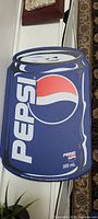Paper folder shaped like a Pepsi 355 mL soda can with the Pepsi logo on front.
