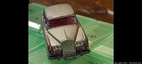 Close-up of the silver Rolls Royce model from front-top showing grill and headlights.