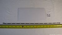 Full length photo of the silver chain measuring 18 inches on a ruler.