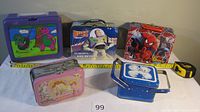 Photo of five children's lunchboxes including Barney, Buzz Lightyear, Spider-Man, Disney, and blue box with bears, showing condition and size.