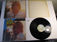Vinyl record, sleeve, and album cover showing Rod Stewart with text 'Foot Loose & Fancy Free'.