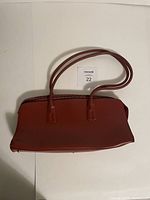 Top view of red leather Furla handbag showing smooth finish and double shoulder straps.