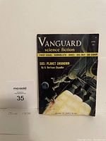 Front cover of Vanguard science fiction magazine June 1958 showing the illustrated rocket launch and featured authors.