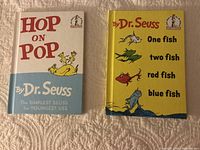 Two hardcover Dr. Seuss books side by side: 'Hop on Pop' with a white and blue cover and 'One Fish Two Fish Red Fish Blue Fish' with a yellow cover.
