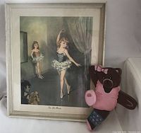 Framed 'Sur Les Pointes' ballerinas print with wooden bear ballerina figurine beside it on a white surface, showing both items together for size and context.