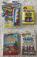 All four items together: two Creative Child Games Travel Fun Boxes, Rose Art Jumbo Chalk, and Balloon Copter.