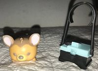 Image of Disney Tsum Tsum Faline figurine and accompanying accessory on fabric surface showing wear details and scale.