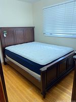 Assembled queen bed with headboard, footboard, side rails, box spring and mattress