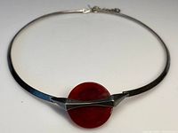 Full view of the Art Deco sterling silver collar necklace showing the central round carnelian plaque and narrow band.
