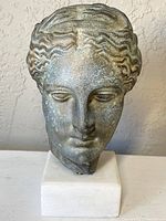Front view of bronze head on marble stand