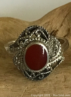 Close-up image showing the full front of the ring with carnelian stone and spiral silver detailing