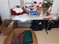 Wide view showing Christmas linens on table and wooden decor in boxes below