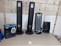 Wide shot showing all five heaters and fan heater box together against a wall.