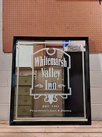 Front view of the framed mirror showing etched text Whitemarsh Valley Inn, established 1991, with proprietors' names Gail & Jimmy
