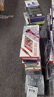 Stack of boxed earbuds and action cameras