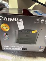 Boxed Canon MAXIFY MB2720 all-in-one printer showing front box design and branding with model number and key features.