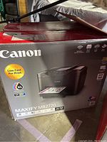 Box of Canon Maxify MB2720 printer showing image of printer and highlighting low cost per print.