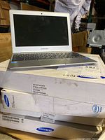 Four Samsung Chromebook 2 notebooks stacked on original sealed boxes with Intel Inside branding.