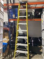 Full view of yellow Husky folding ladder standing upright showing overall design and height.