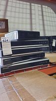 Four black HIK Vision security recorders stacked on top of each other with a small Seneca Windows 7 Pro computer on top.