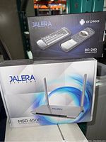 Photo showing Jalera MSD-6500 streaming device with dual external antennas alongside boxed RC-240 remote control.
