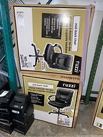 Two boxes of Ruzzi mid-back chairs stacked on a pallet with product images and features on box