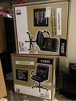 Two boxed mid-back office chairs labeled 'ruzzi' with product specifications visible on boxes