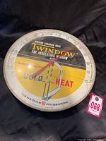 Front view of round vintage thermometer with Twin-Window advertising, showing cracked top cover and temperature scale.