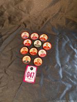 Full set of 10 vintage hockey coins arranged on fabric background showing front photos of players and one staff member.