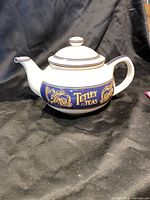 Side view of the vintage Tetley Teas ceramic tea pot showing the brand logo and decorative detailing