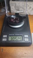 Garnet crystals on a digital scale showing total weight of 30.525 carats.