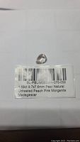 Pear-shaped natural pink peach morganite gemstone placed on a white background with certification label indicating 1.69ct, 9.7x7.6mm, untreated, from Madagascar.
