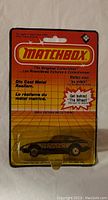 Front view of the sealed Matchbox toy car in original card packaging, showing the car model and branding.
