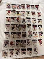 Front view of 48 Esso hockey player stickers arranged in grid pattern on white surface.