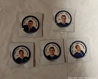 Front side of five Toronto Maple Leafs hockey coins featuring player portraits and names from 1946-1967 era.