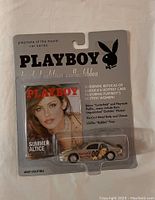 Front view of sealed Playboy collectible car in original blister packaging with Summer Altice on magazine cover insert