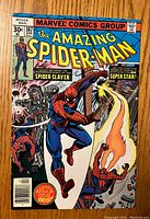 Front cover photo showing The Amazing Spider-Man #167 with Spider-Man fighting a villain and colorful artwork.