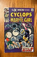 Front cover of vintage X-Men comic book issue #48 featuring Cyclops and Marvel Girl in action against armored adversaries, with 12 cent price and Marvel Comics logo.