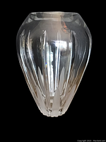 Front view of the clear crystal vase showing rounded body with vertical cut facets tapering from neck to base.