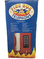 Original packaging box front showing Fire Box Telephone branding and model FB-911 by Randix, listing features such as flashing light, memory buttons, and mounting options.