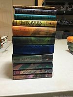 Stacked view of the full Harry Potter hardcover book series plus Harry Potter and the Cursed Child.