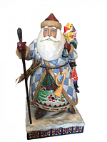 Front and side view of Jim Shore Santa figurine showing blue and white diamond pattern coat, red mittens, staff, and green toy sack with toys.