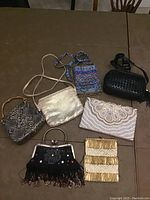 Overview photo of all seven vintage purses showing various textures and styles including sequin, beaded, faux snake print, and woven leather.