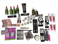 Top-down view of all cosmetic items arranged, showing variety of brands and types including pigment bottles, tubes, round tubs, and boxed polishes.