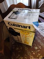 Original box for Cuisinart Pulp Control Citrus Juicer model CCJ-500, shows branding and product features.