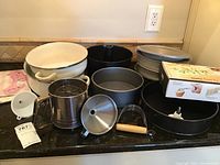 Full view of bakeware including pie pan, springform pans, bundt pan, roasting pan, pastry blender, funnel, flour sifter, and decorating kit.