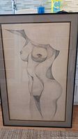 Full view of the framed stylized naked woman pencil sketch showing the entire artwork and frame.