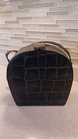 Front view of dark green handbag showing faux crocodile pattern and hard case structure