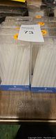 Packaging showing 6 white menorah candles in long, slender shape, through clear plastic casing.